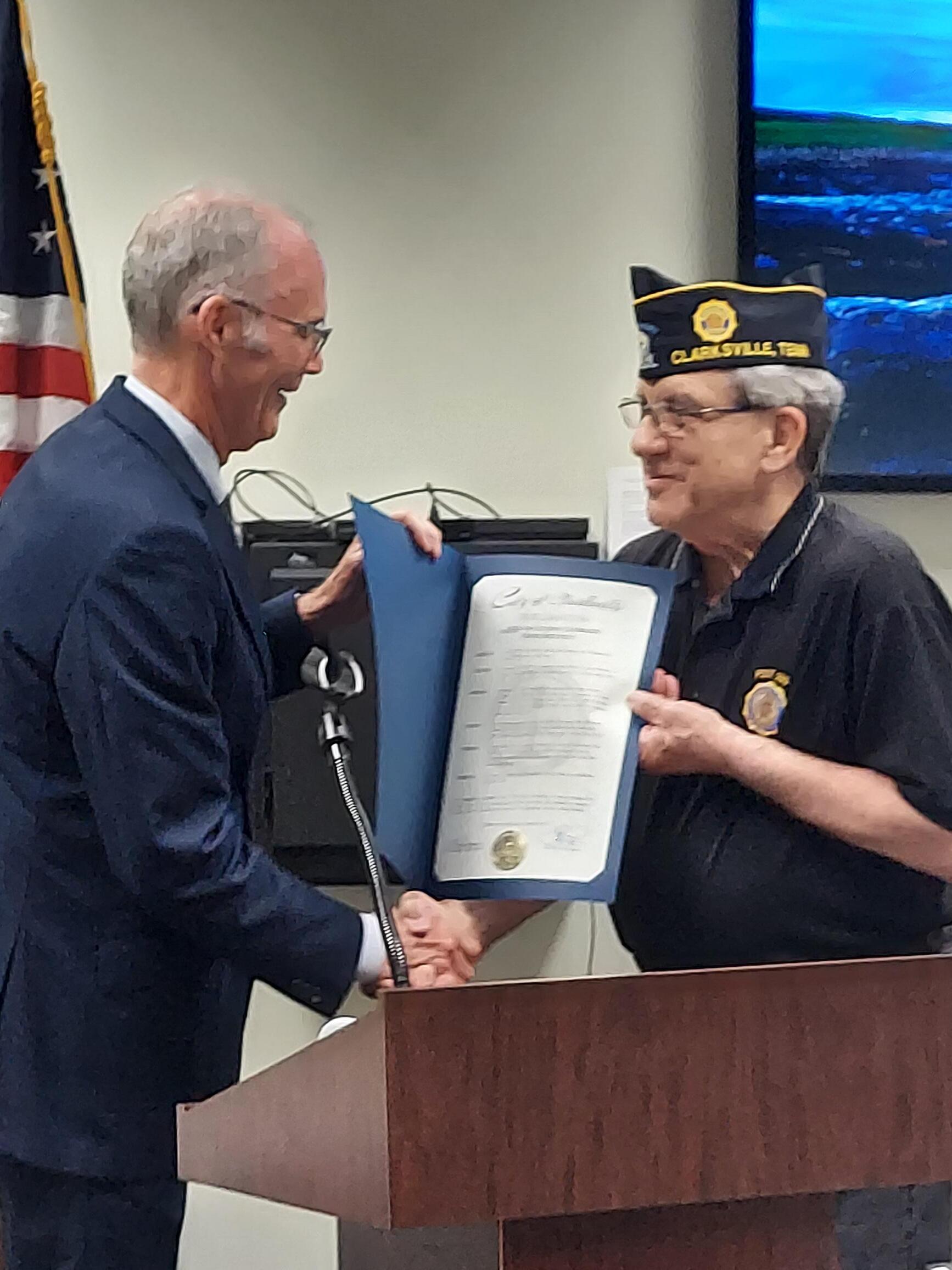 Commander Cherry receives the Proclamation from the Mayor's Office