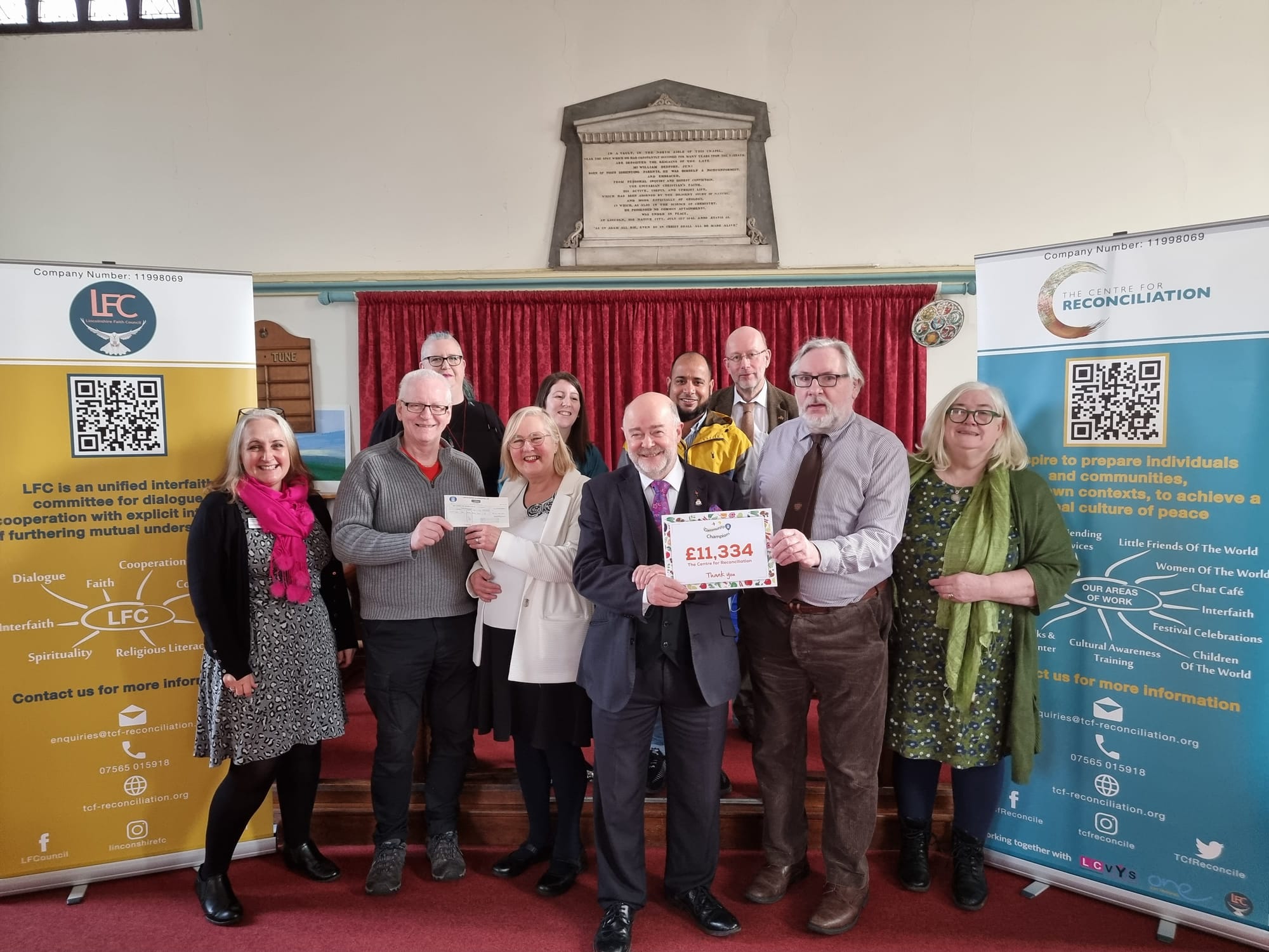 Board members receiving the Cheque from the Community Co-Ordinator