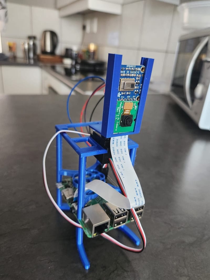 Enhanced Camera Target Tracking Using a Low-cost Thermal Camera