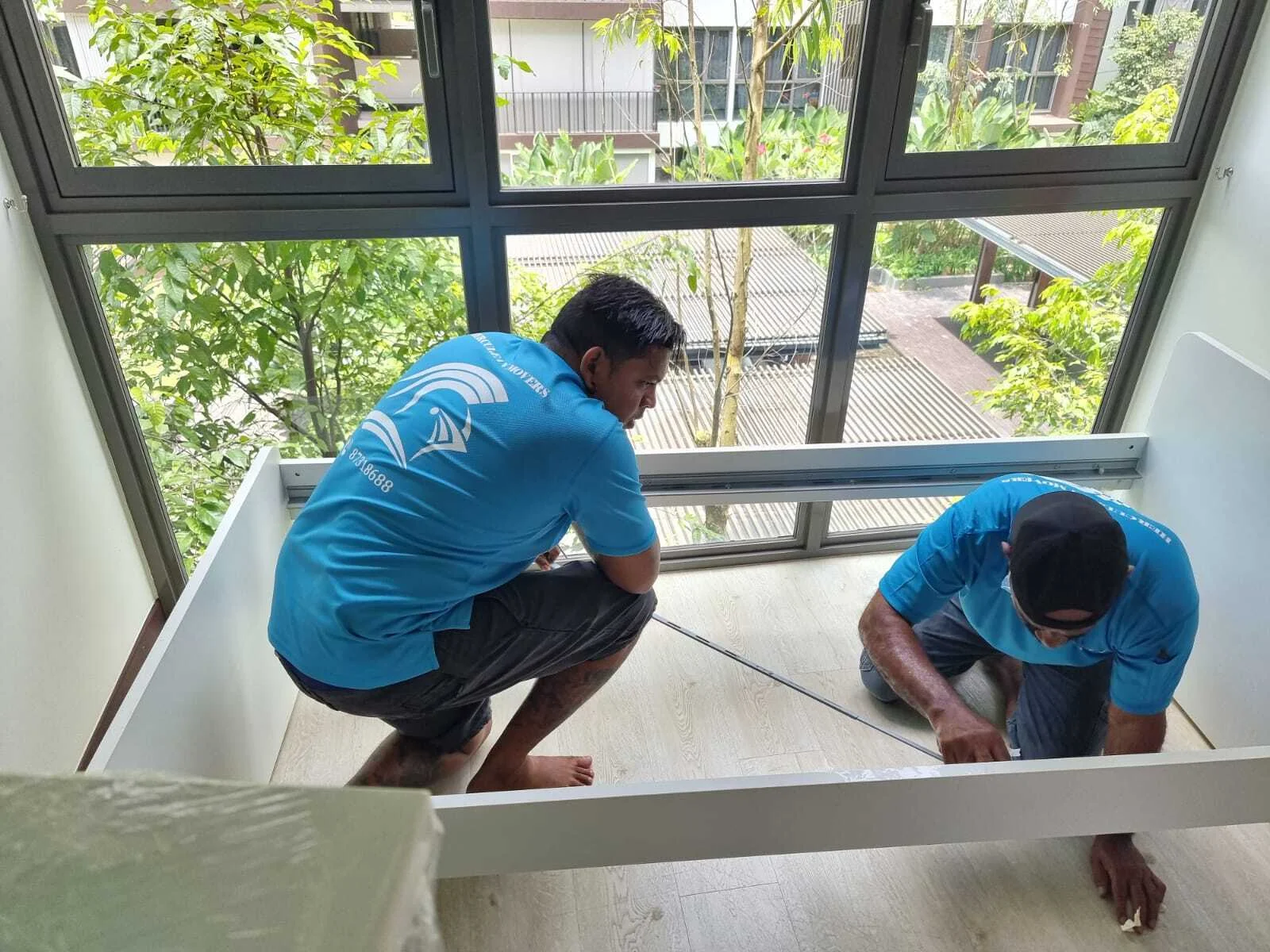 movers inspecting bed frame