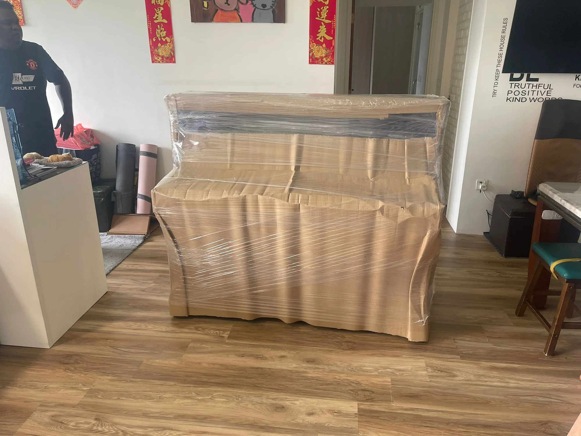 cardboard wrapped piano