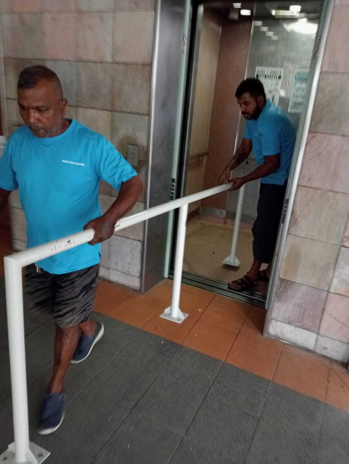 movers carrying iron railings