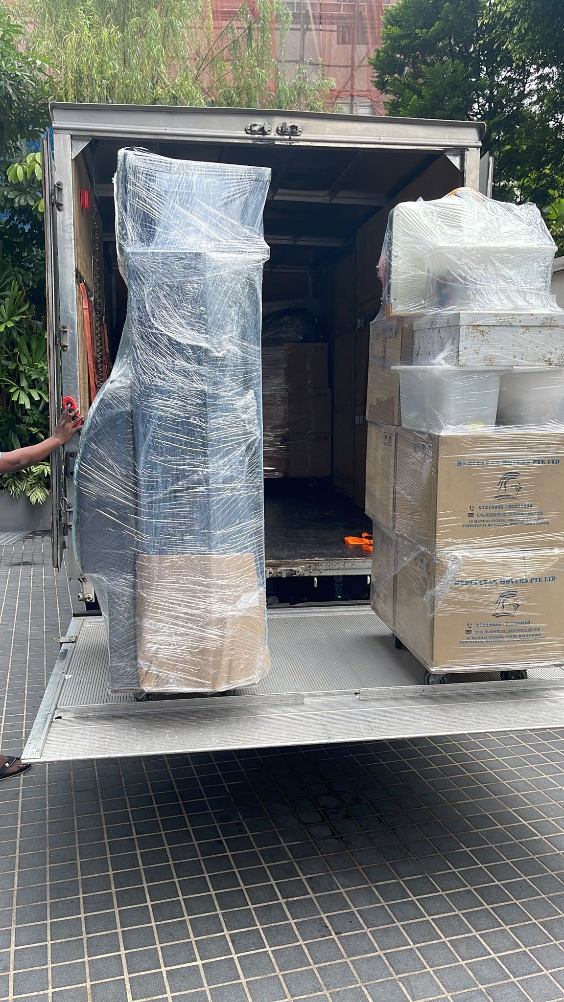 Movers loading cartons into lorry