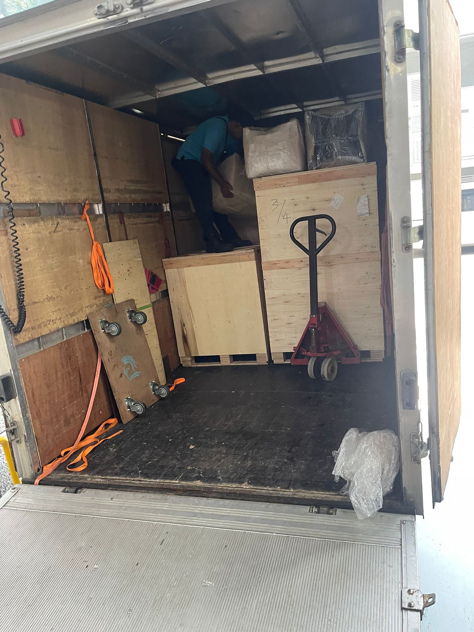 crates loaded in lorry with pallet jack