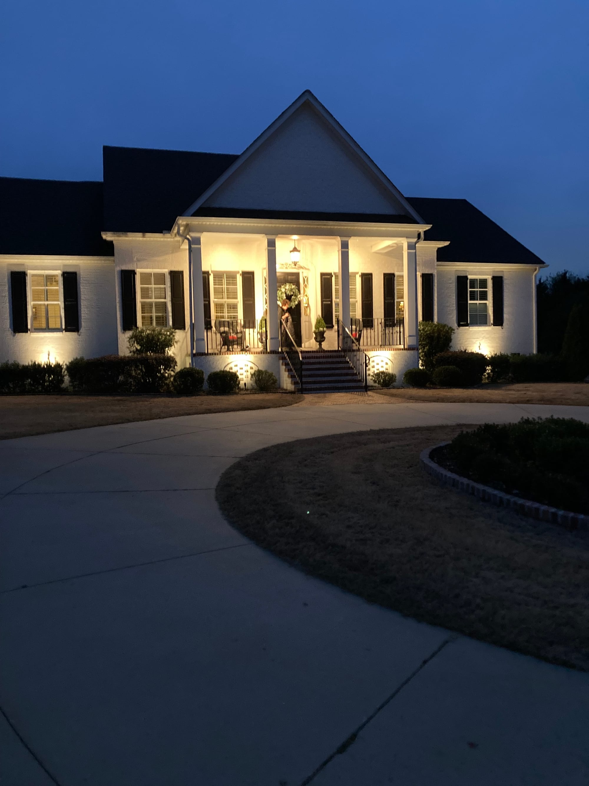 Landscape lighting on white house