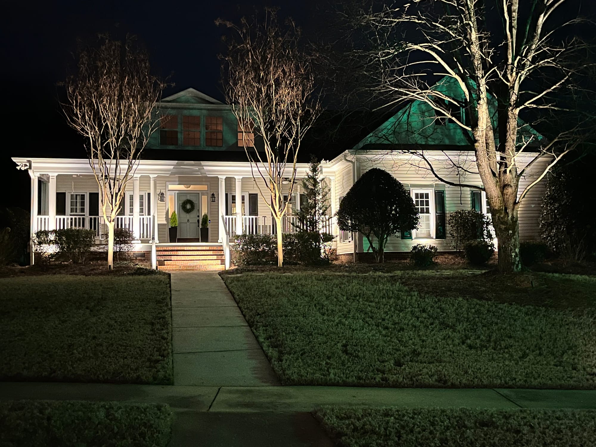 Landscape lighting on cream color house