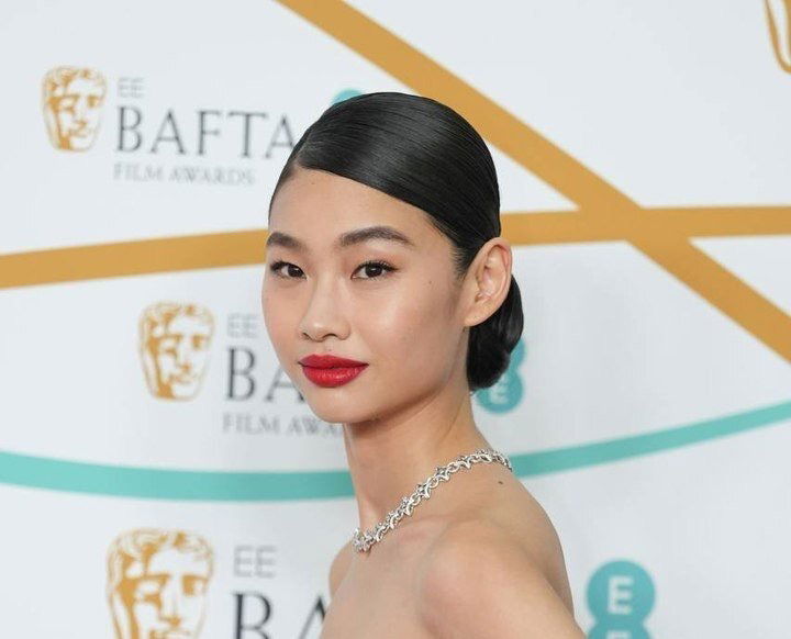 Hoyeon Jung Gleams in Gold Metallic Louis Vuitton Dress, Diamonds & Hidden Heels at BAFTA Red Carpet 2023