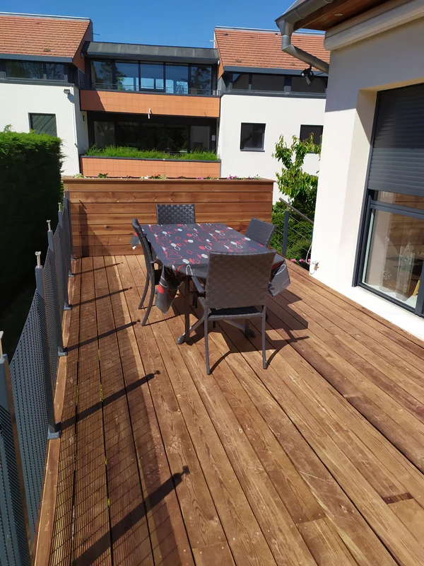 Terrasse en pin autoclave marron, bac à plantes et escalier bois