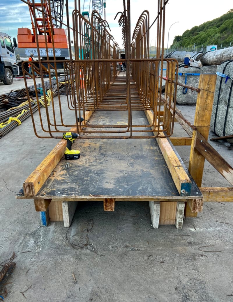 The fabricating, placing and fixing of Pile Plugs, Head Stocks, Capping Beams, Retaining walls and Deck Slabs.