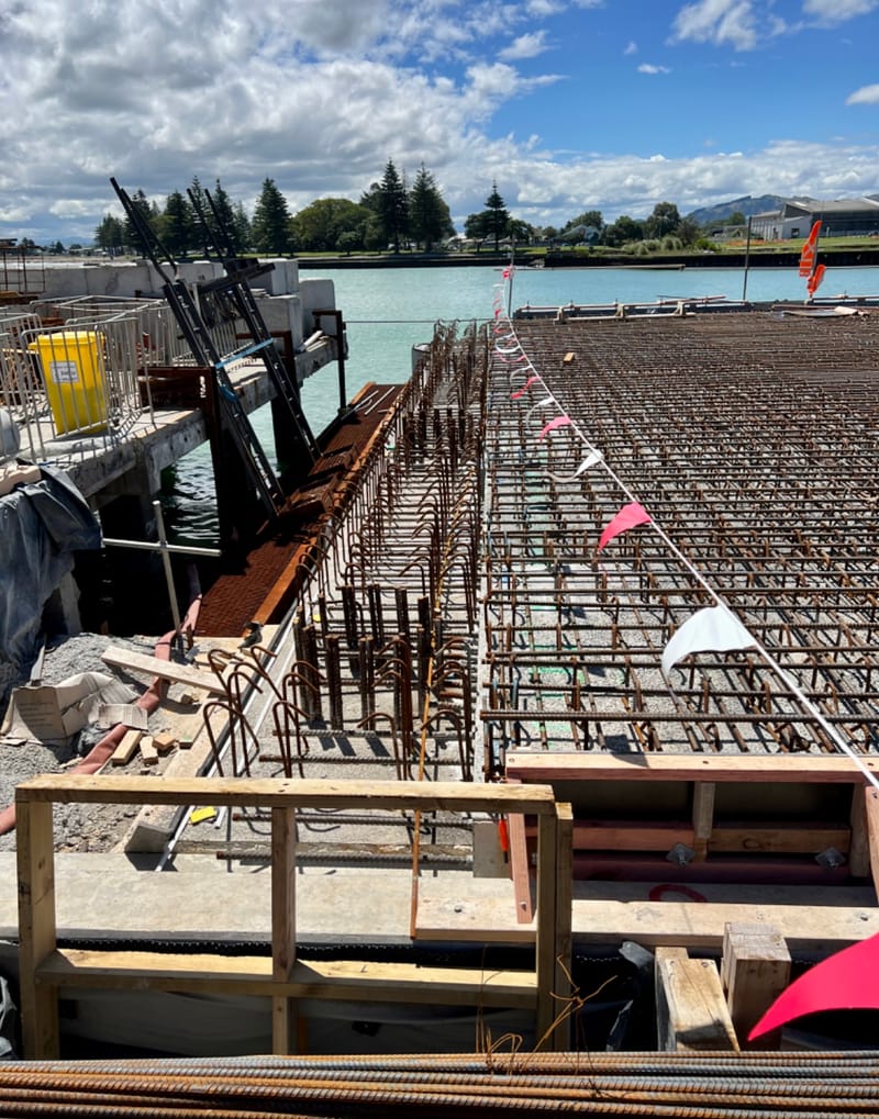 The fabricating, placing and fixing of Pile Plugs, Head Stocks, Capping Beams, Retaining walls and Deck Slabs.