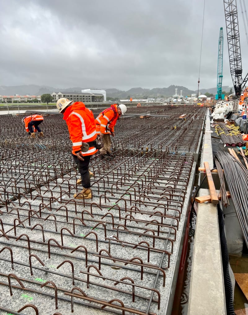 The fabricating, placing and fixing of Pile Plugs, Head Stocks, Capping Beams, Retaining walls and Deck Slabs.