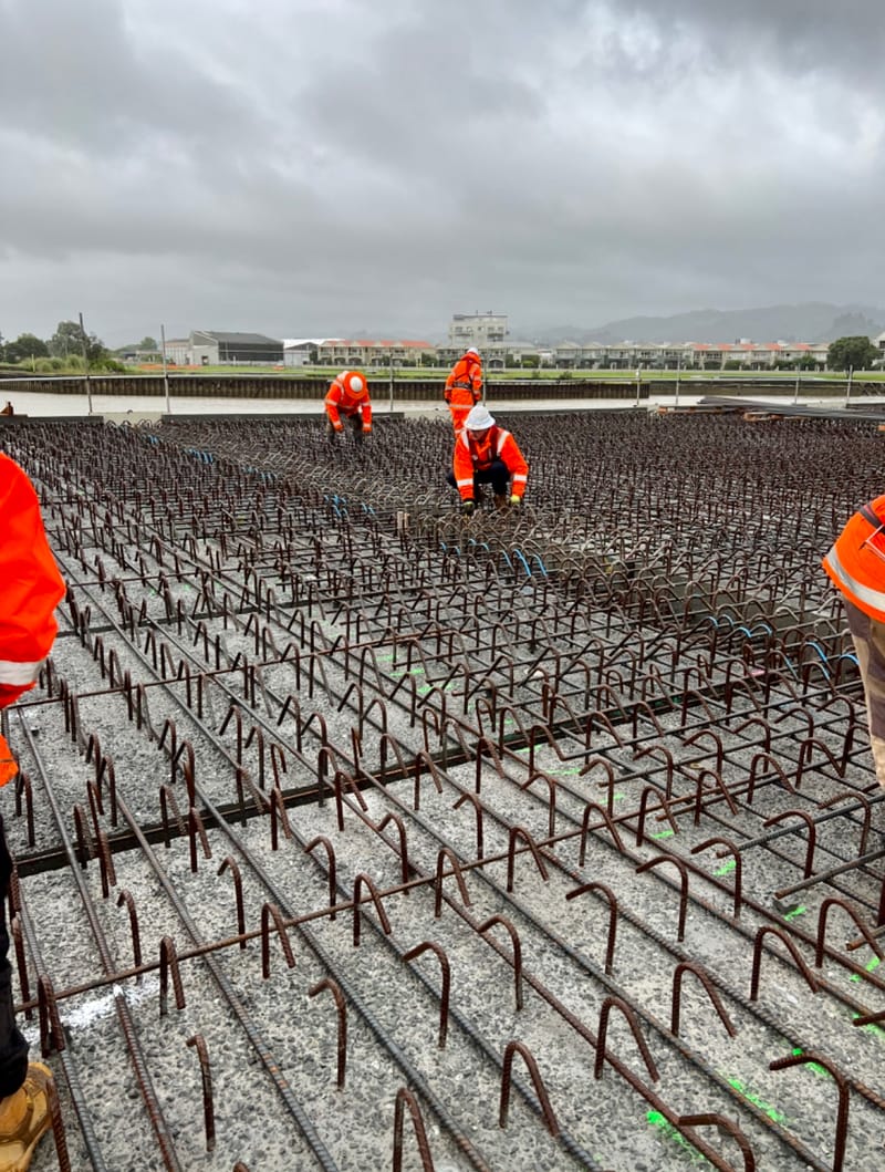 The fabricating, placing and fixing of Pile Plugs, Head Stocks, Capping Beams, Retaining walls and Deck Slabs.