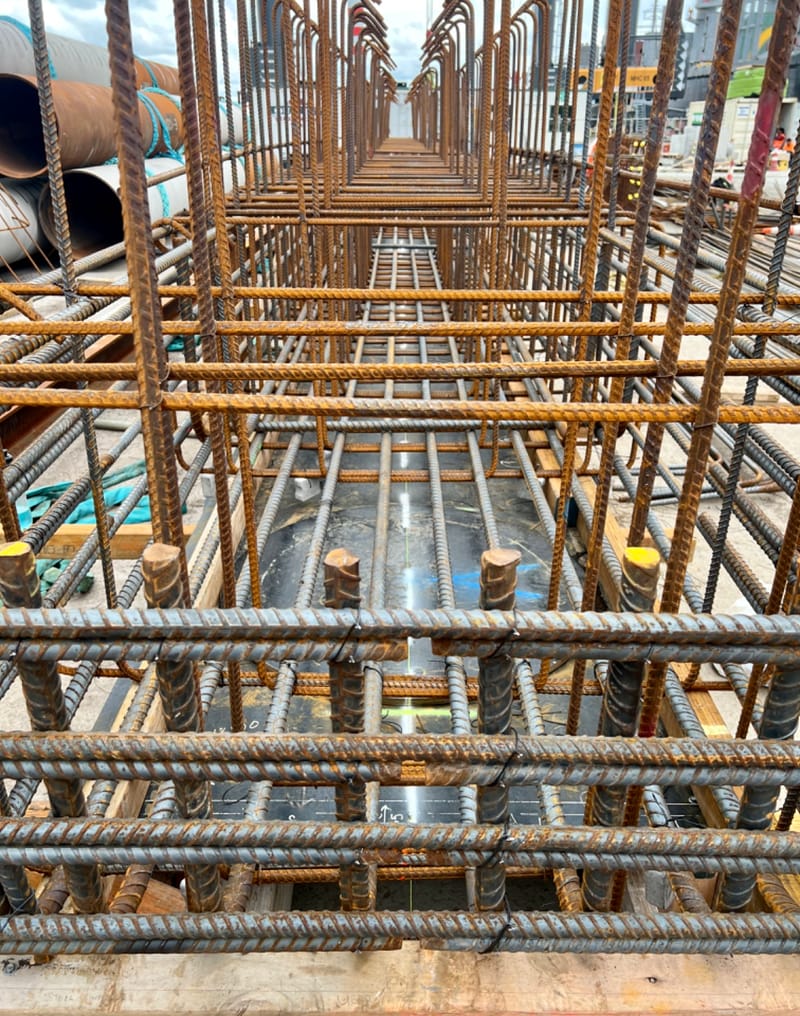 The fabricating, placing and fixing of Pile Plugs, Head Stocks, Capping Beams, Retaining walls and Deck Slabs.