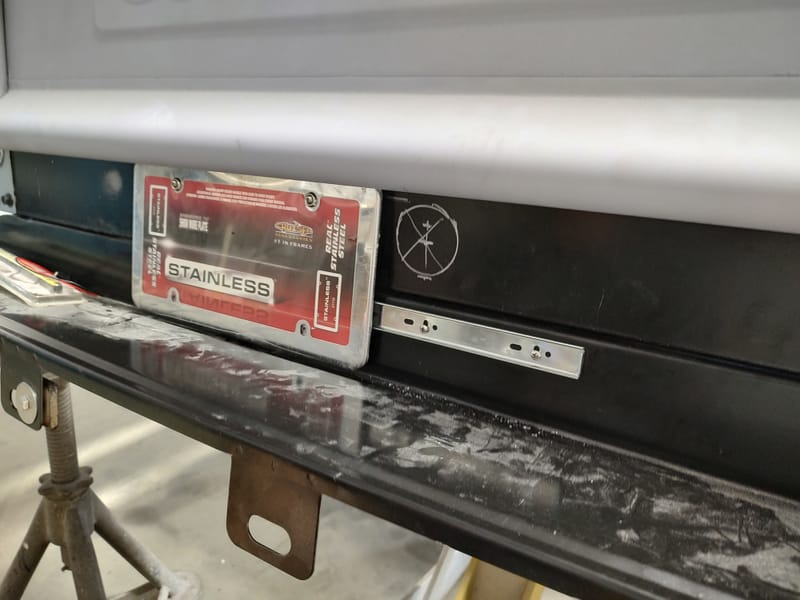 Hidden gas filler for a 49 Chevy truck, designed with a sliding license plate and magnets to avoid putting a large hole in the new wood bed.