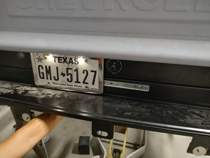 Hidden gas filler for a 49 Chevy truck, designed with a sliding license plate and magnets to avoid putting a large hole in the new wood bed.