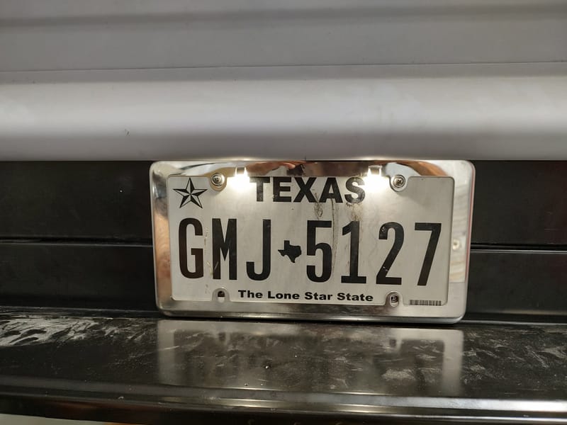 Hidden gas filler for a 49 Chevy truck, designed with a sliding license plate and magnets to avoid putting a large hole in the new wood bed.