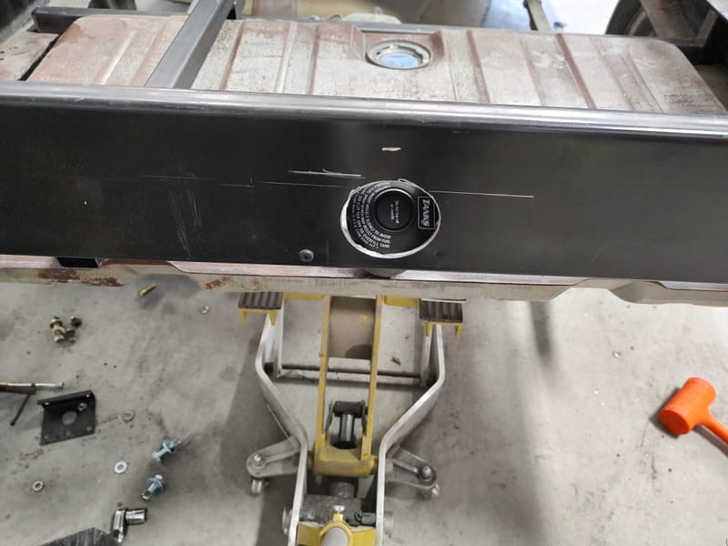 Hidden gas filler for a 49 Chevy truck, designed with a sliding license plate and magnets to avoid putting a large hole in the new wood bed.
