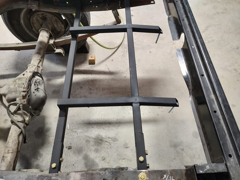 Hidden gas filler for a 49 Chevy truck, designed with a sliding license plate and magnets to avoid putting a large hole in the new wood bed.