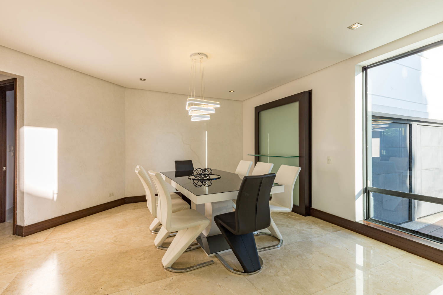 "Savor Unforgettable Moments: Experience Fine Dining in the Elegant Ambiance of our Medellin Villa's Dining Room"