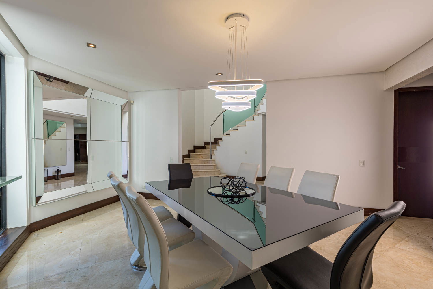 "Savor Unforgettable Moments: Experience Fine Dining in the Elegant Ambiance of our Medellin Villa's Dining Room"