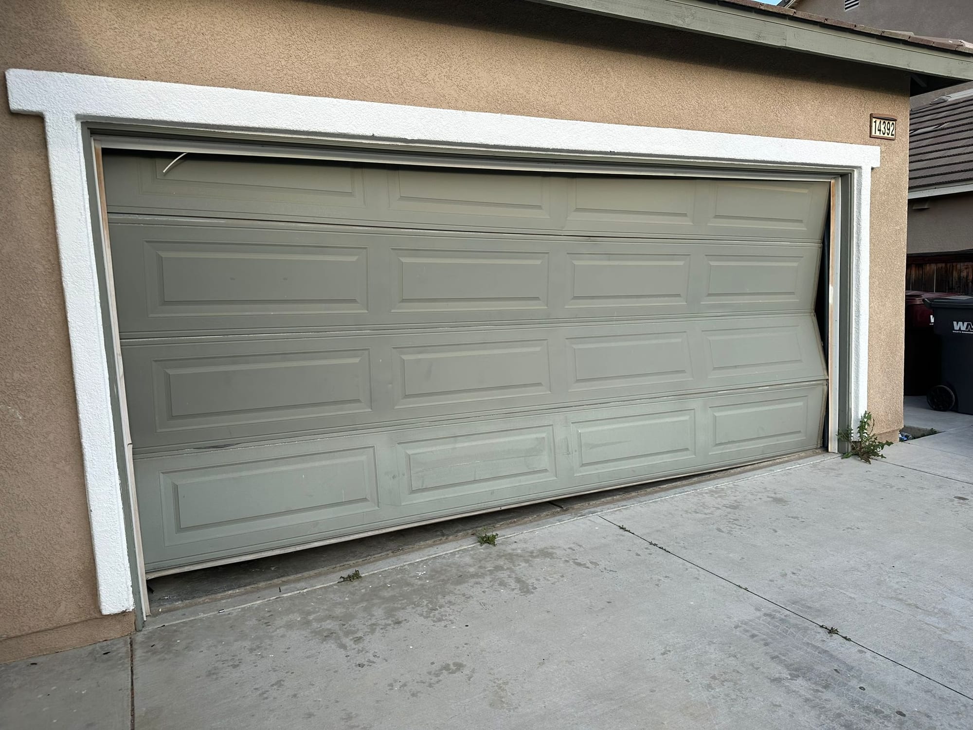 Dented and Misaligned Garage Door