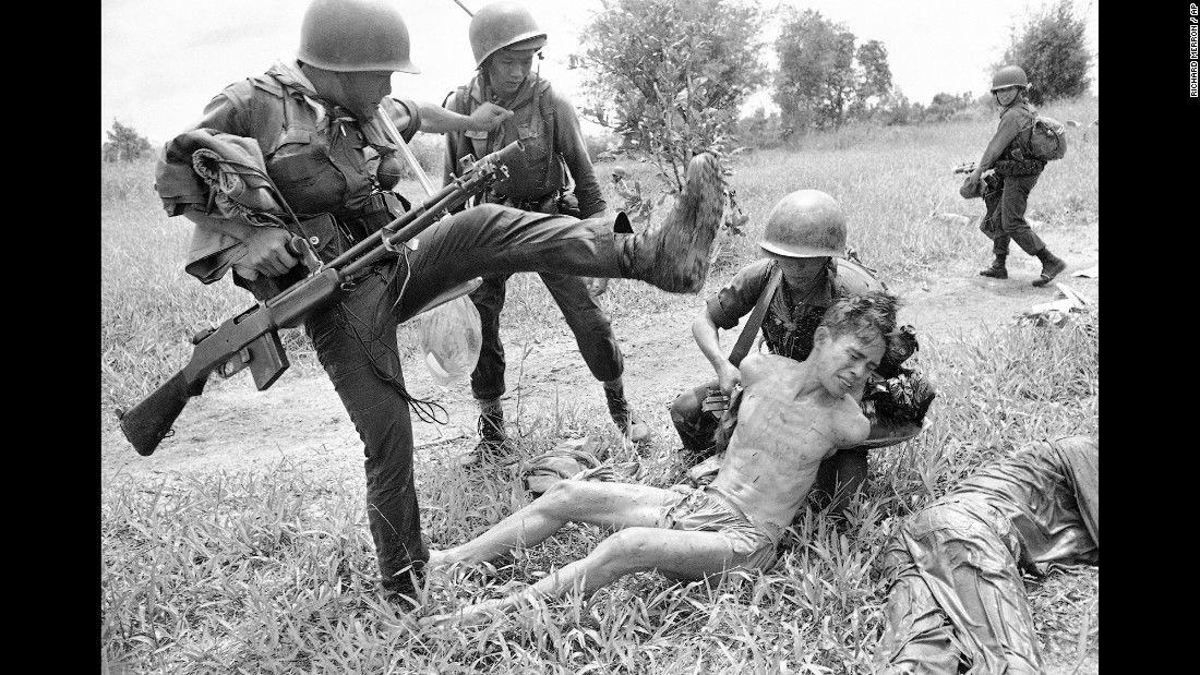 Vietnam War, A suspected Viet Cong is kicked by a South Vietnamese soldier in October 1965