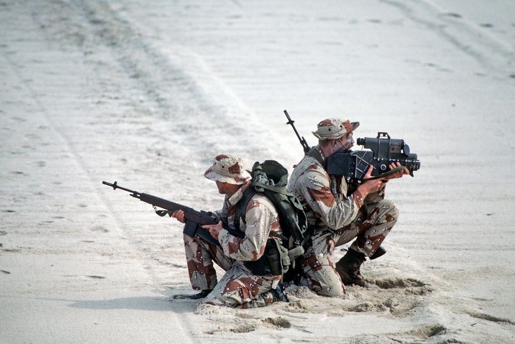 Gulf War Sea-Air-Land (SEAL) team members, one equipped with an AN PAQ-1 laser target designator, right, the other armed with an M14 rifle,
