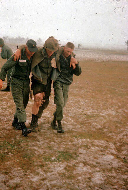 Vietnam War 2 Soldiers aiding an injured soldier