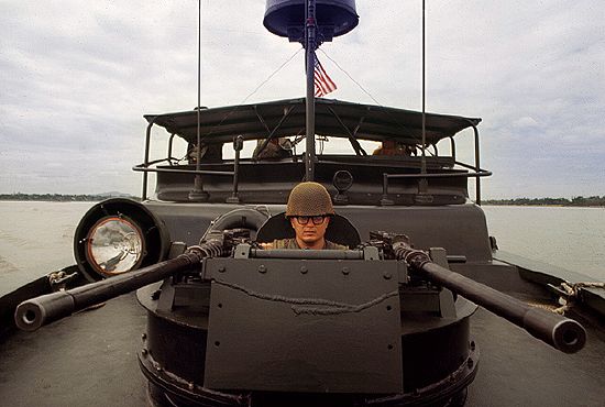 Vietnam War  US Navy PBR (Patrol Boat, River) gunner en route to Hué, Vietnam, 1968