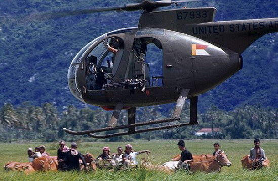 Vietnam War US army Loach scout helicopter corrals Vietnamese villagers and their livestock near Ba Xoai, 1968