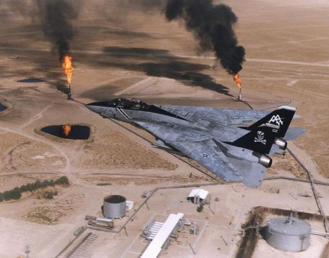 Gulf War  destruction and damage caused by Operation Desert Storm was plentiful. Here, an F-14A Tomcat is flying over Kuwaiti. The burning areas are more oil fields