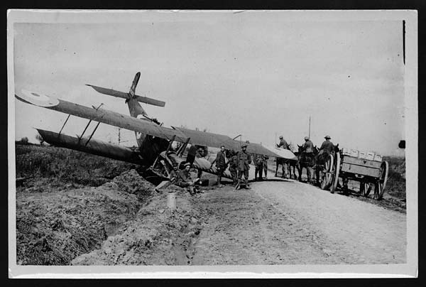 World  War 1  British aeroplane in a ditch by the roadside, near Boesinghe. It is impossible to tell from this photograph whether it has crash-landed or has had difficulty taking off. The number on the tail i