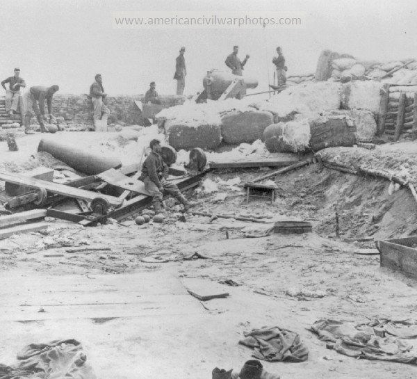 Civil War Confederate fortifications, Yorktown, Virginia. LOC Summary, 8 men at sand-bagged cannon emplacement; man in mid-ground seated on wreckage of cannon