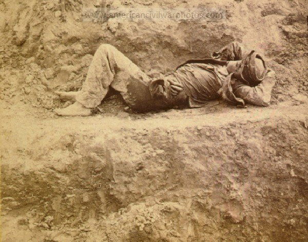 Civil War Dead rebel soldier, barefooted, killed by a shell, which tore his side out The entrails are protruding from his side. This view was taken in the trenches before Petersburgh sic, Virginia, April 2d,