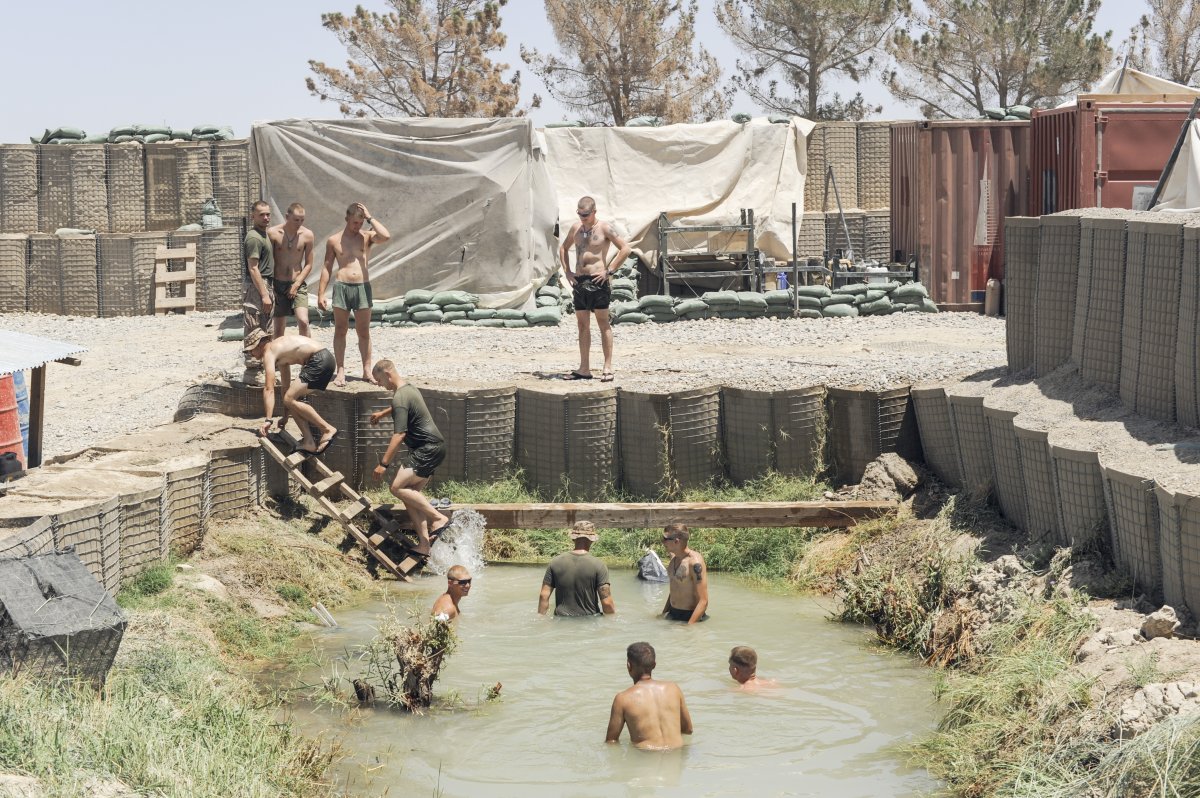Afghanistan War Marines swim in an irrigation canal at their outpost in Helmand Province, Afghanistan. The same day, a patrol from another base was hit by an IED