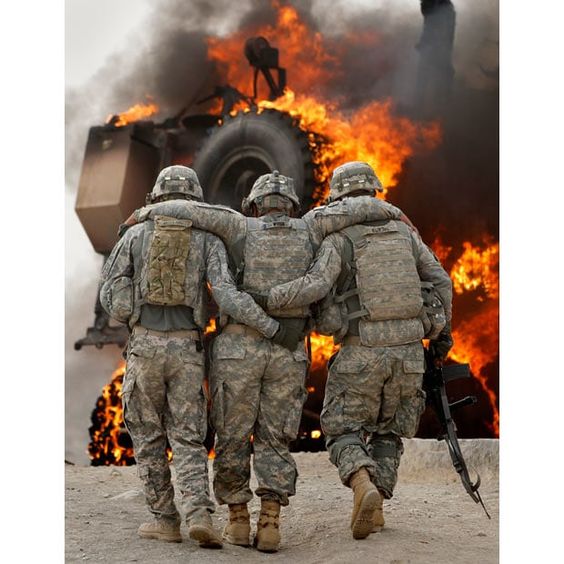 Afghanistan War July 23, 2010, A soldier with an injured ankle  is assisted past his burning M-ATV armored vehicle after it struck an Improvised Explosive Device