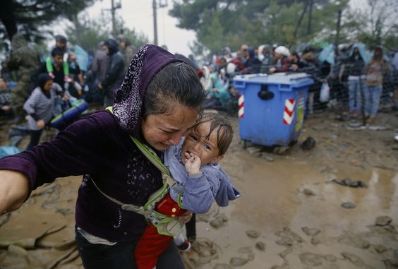 Iraq War A Syrian refugee cries as she carries her baby through the mud to cross the border from Greece into Macedonia during a rainstorm, near the Greek village of Idomeni, Sept. 10, 2015.