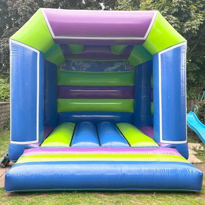 Multi coloured, blue fronted bouncy castle