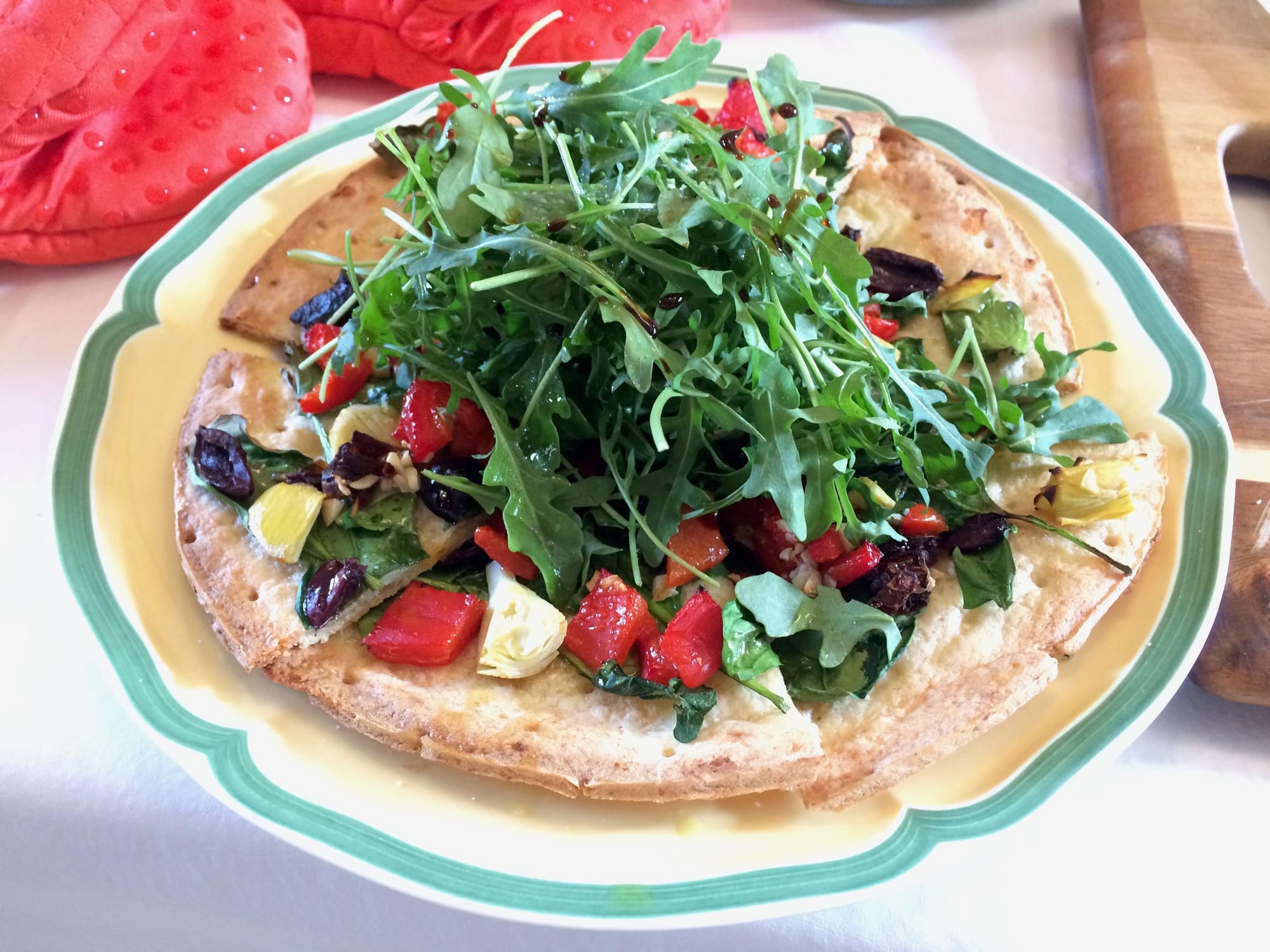Roasted Veg GF Pizza topped with Arugula