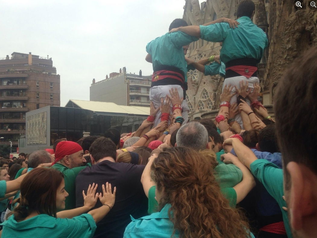 A photo of me taking part of a human "castell" (castle in Catalan), which is recognised as an intangible heritage activity by UNESCO. Each clan builds several tiers to reach the highest.