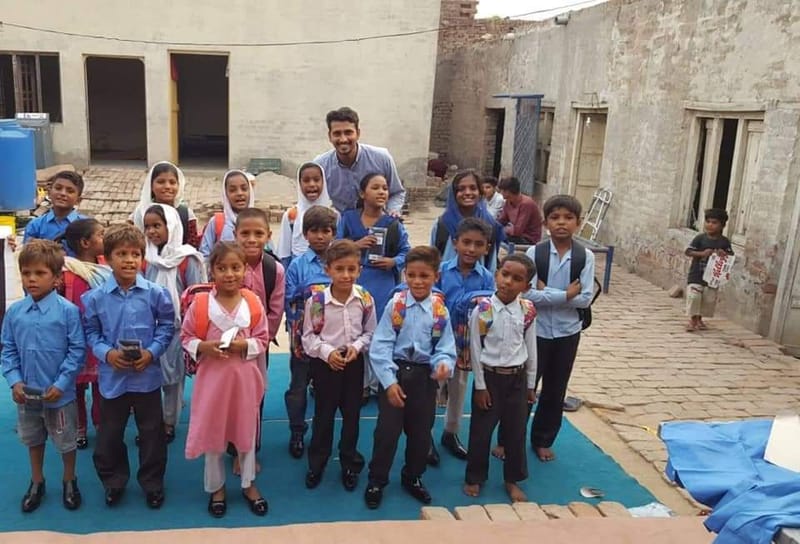 Distribution of Uniforms, School Bags, Shoes to Kids